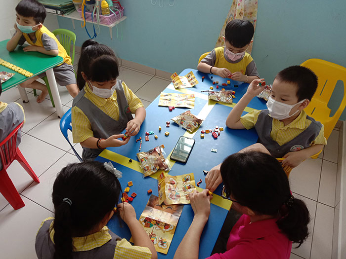 Children at Genius Kids’ Land building their LEGO Monkey King together with a teacher